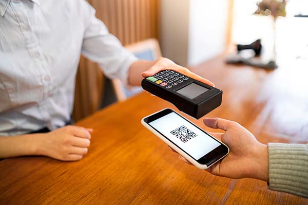 Person making a contactless payment with mobile phone.